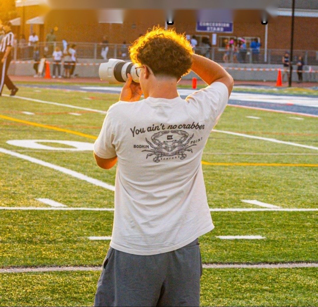 Aiden shooting on the sideline at golden hour